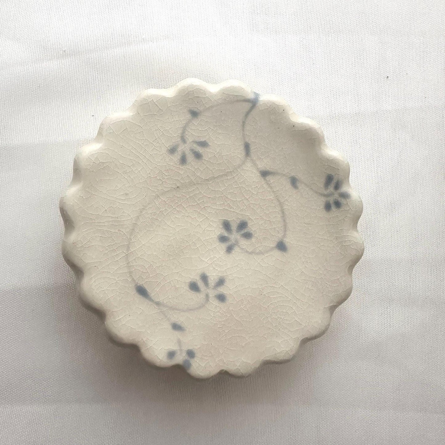 Handmade and hand painted pottery trinket dish, with handpainted blue underglaze and finished in a clear glaze, 3” with foot