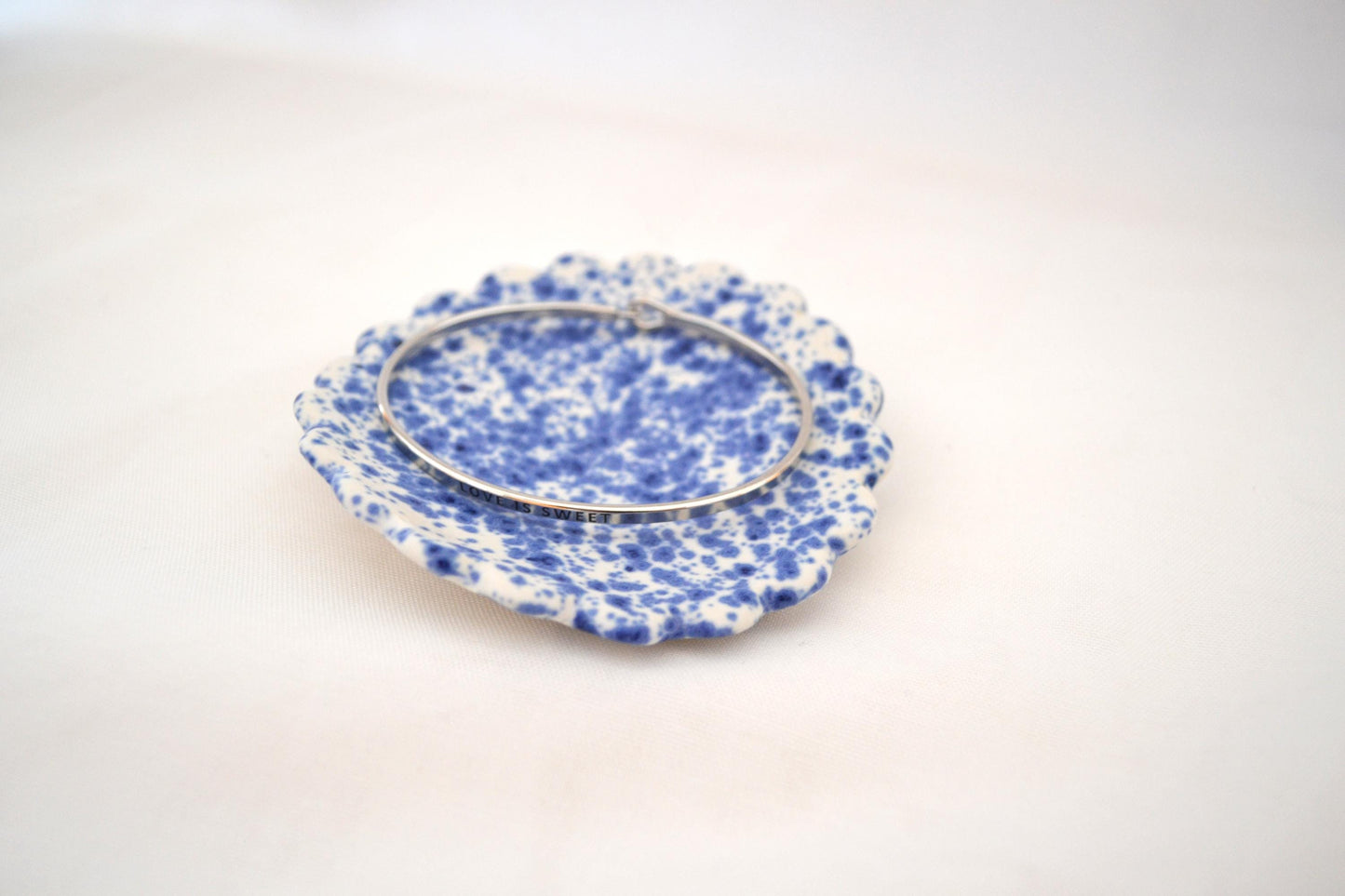 Handmade trinket dish with scalloped edges and vibrant blue splatterware glaze, Matte Finish, 3 Inches Diameter