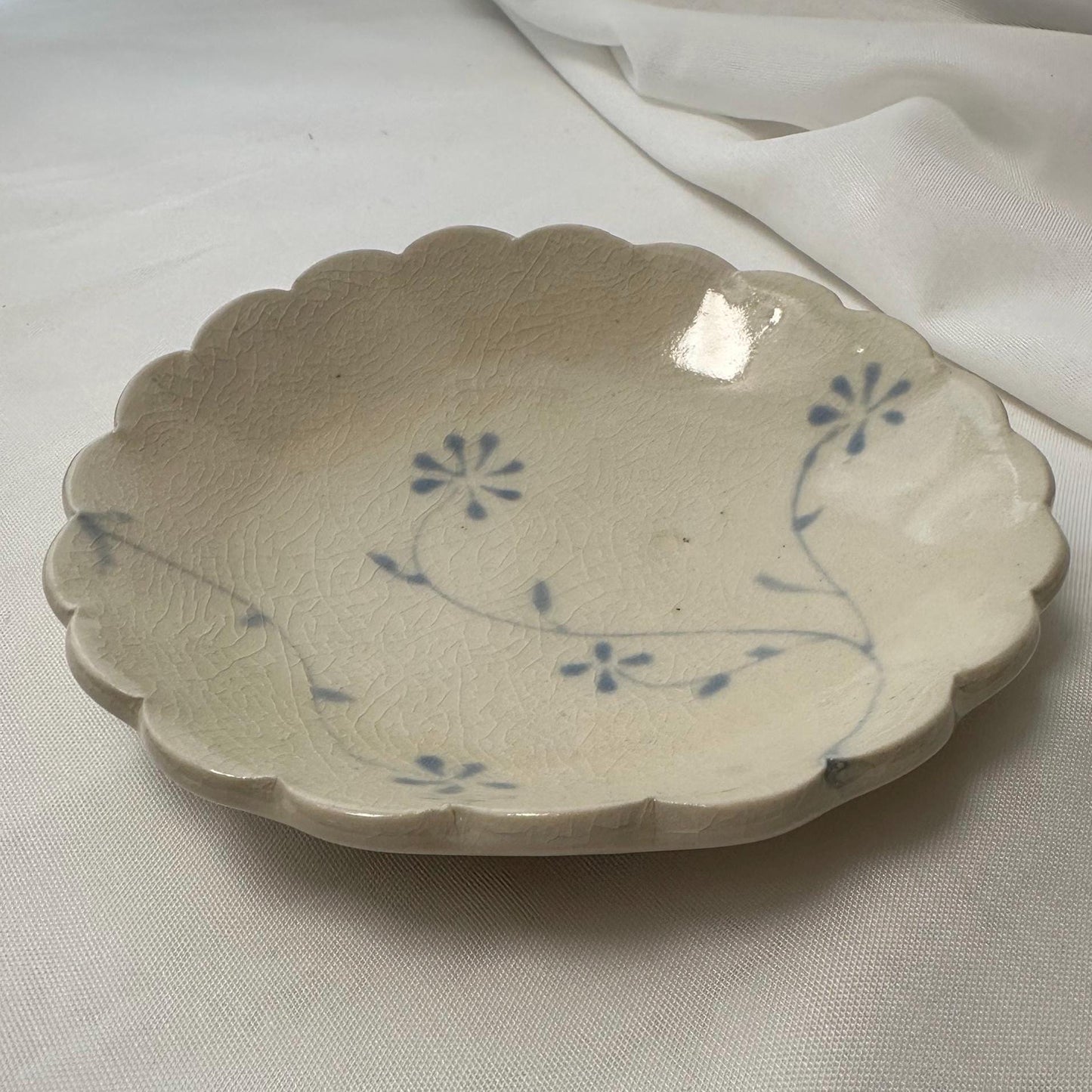 Handmade shallow scalloped bowl, with handpainted blue underglaze and finished in a clear glaze, 5”