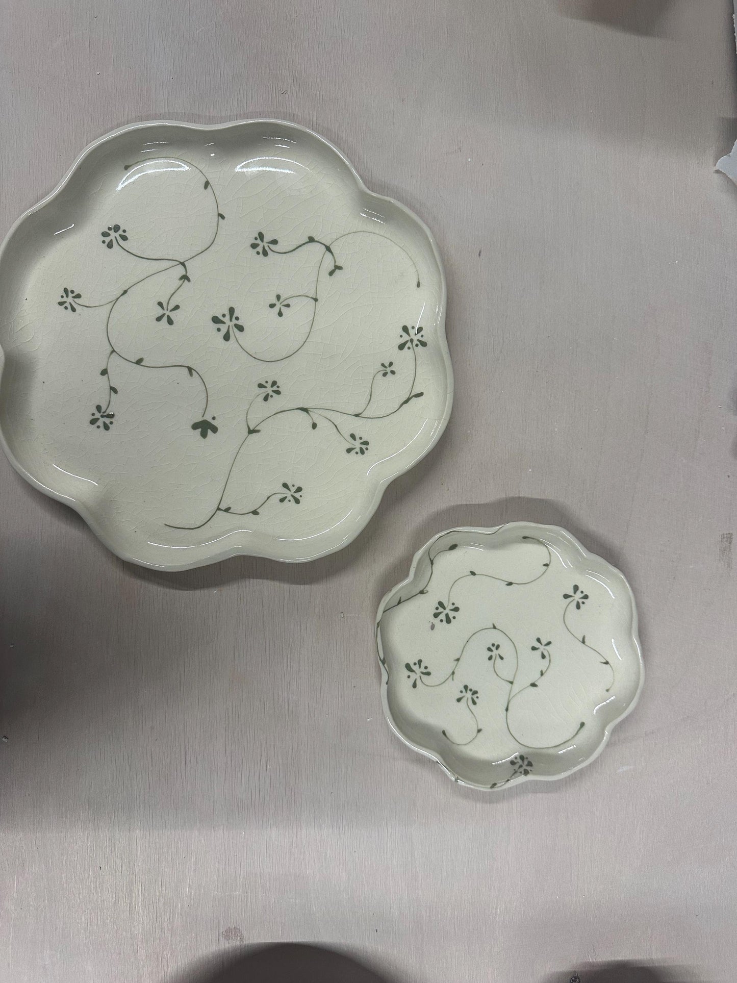 Handmade and hand painted pottery plate, scalloped edges, floral design hand painted in a sage green, finished with a clear crackle glaze