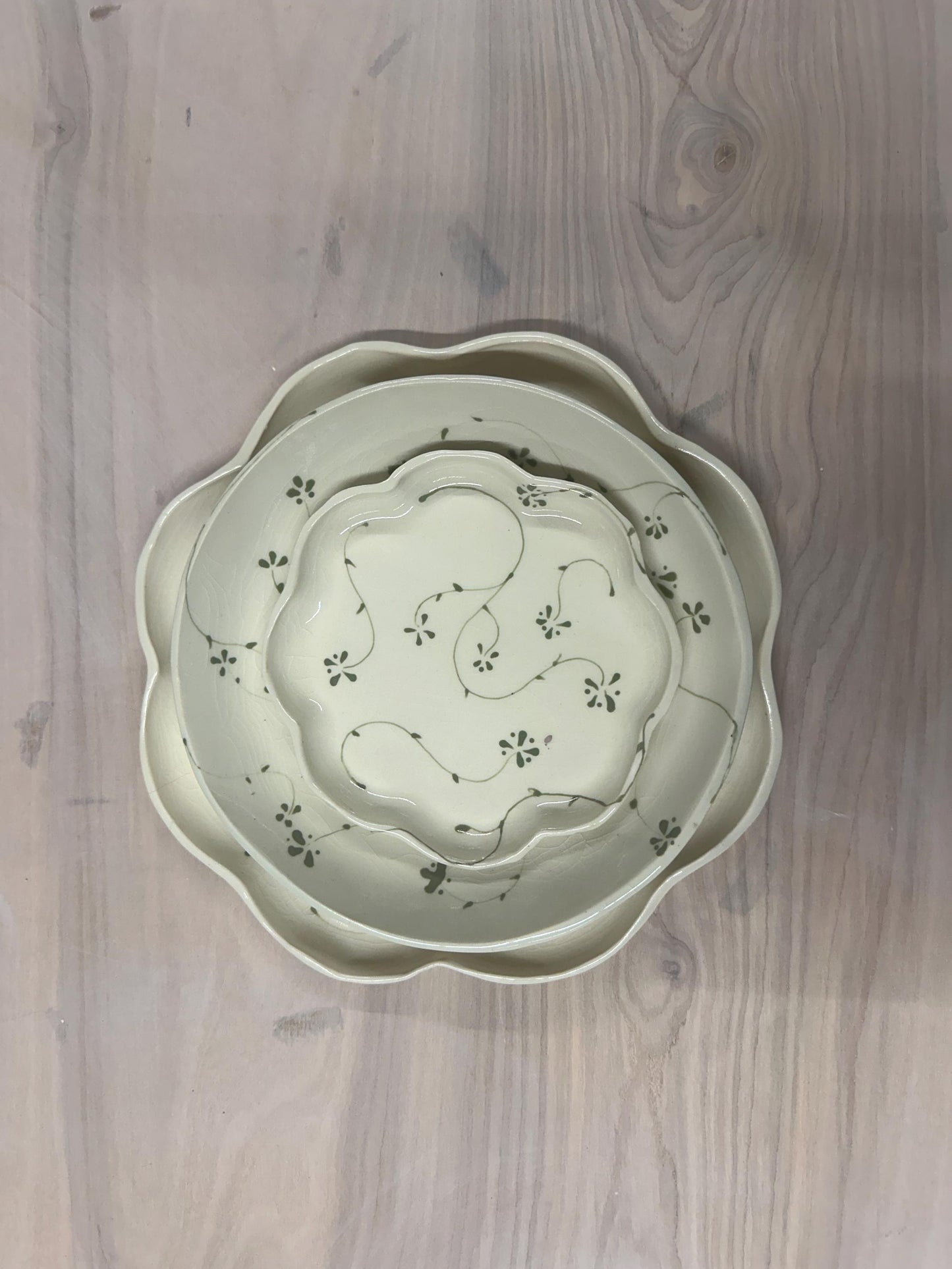 Handmade and hand painted pottery plate, scalloped edges, floral design hand painted in a sage green, finished with a clear crackle glaze
