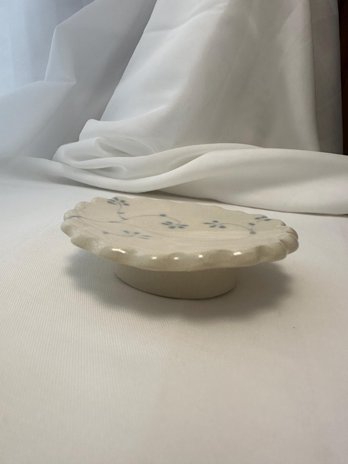 Handmade and hand painted pottery trinket dish, with handpainted blue underglaze and finished in a clear glaze, 3” with foot
