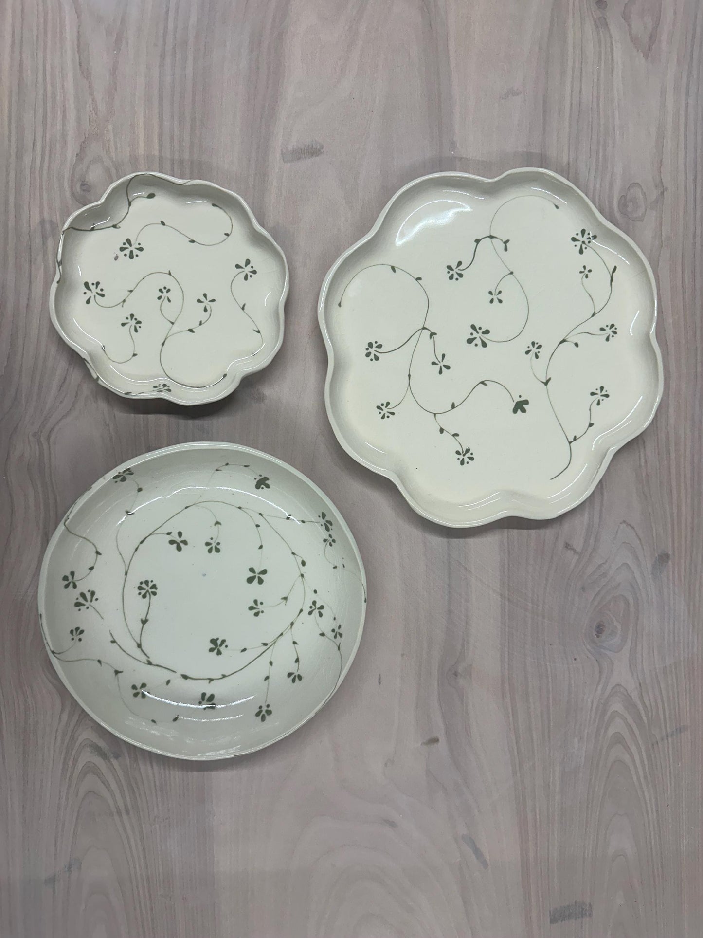 Handmade and hand painted pottery plate, scalloped edges, floral design hand painted in a sage green, finished with a clear crackle glaze