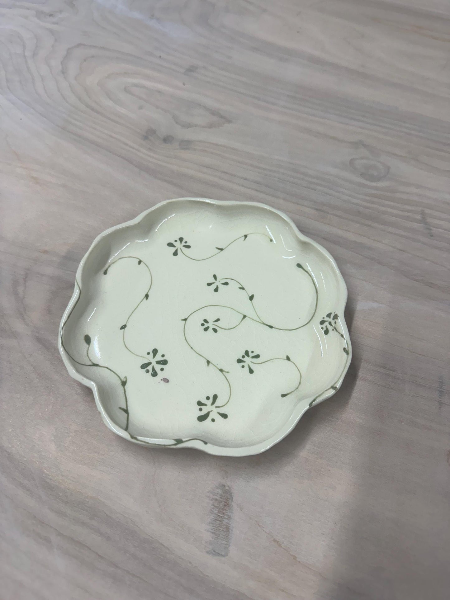 Handmade and hand painted pottery plate, scalloped edges, floral design hand painted in a sage green, finished with a clear crackle glaze